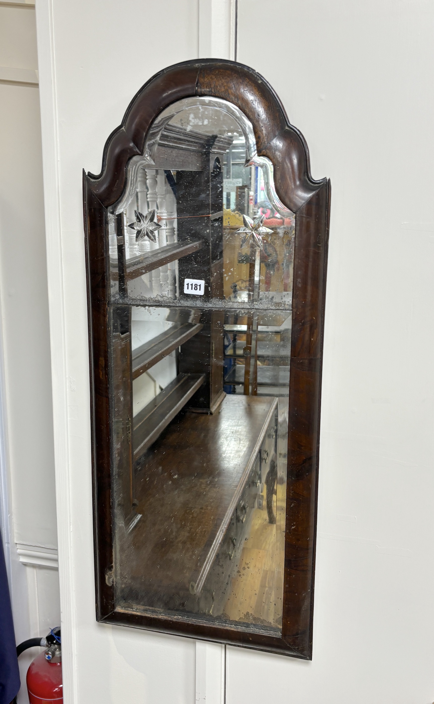 An early 18th century walnut cushion framed wall mirror, width 38cm, height 90cm